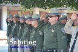 A contingent of California Highway Patrolmen salute during a solemn ceremony held Wednesday at the Kings County Government Center.